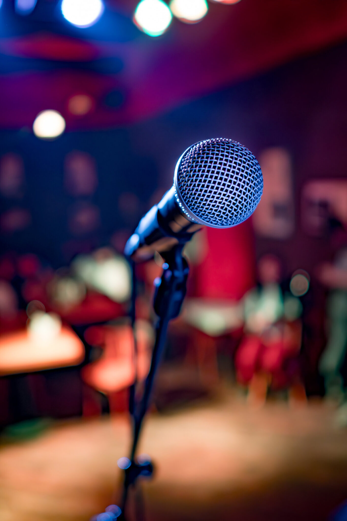 Microphone on stage against a background of auditorium.